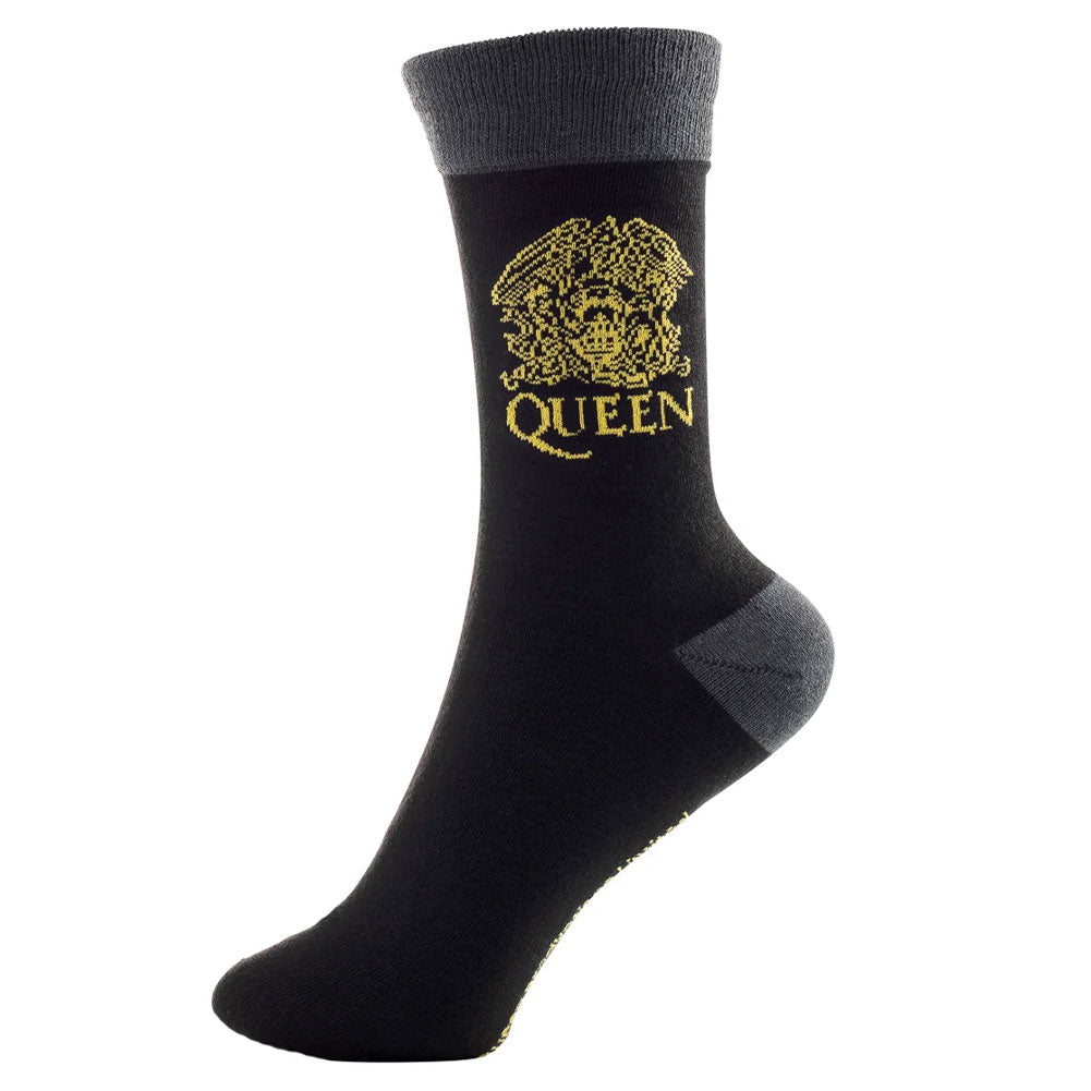 A pair of black socks with the Queen gold logo on the ankle