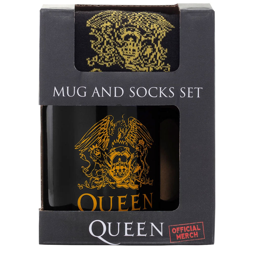 A black mug with the queen logo in gold and a pair of black socks with the same gold logo in the packaging